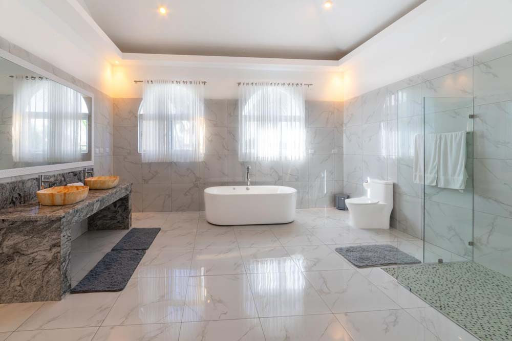 Spacious bathroom with bathtub and shower in a villa at Playa Palmera Beach Resort