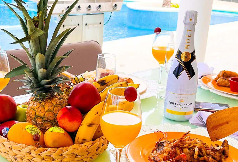 Fruit, drinks and pool at the villa at Playa Palmera Beach Resort