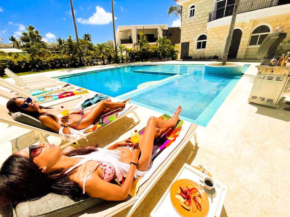 Sunbathing by the pool in a villa at Playa Palmera Beach Resort