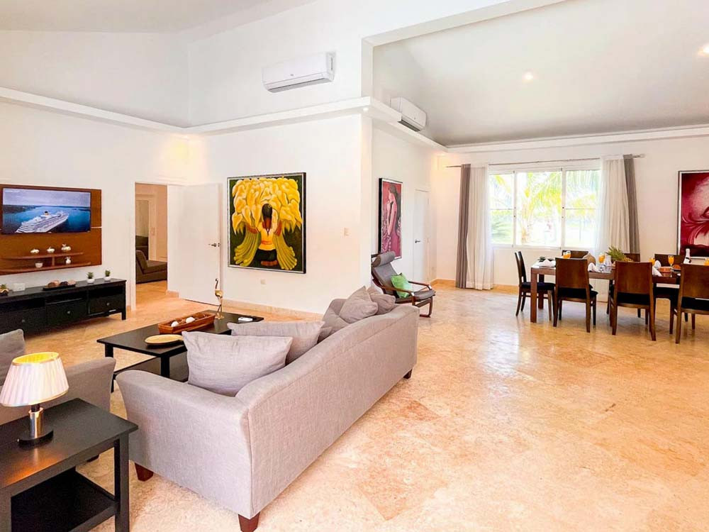 Spacious living room and dining room in the background in the villa at Playa Palmera Beach Resort