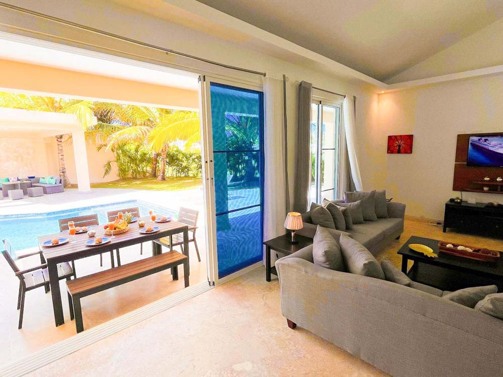 Living room, dining room and view of private pool in villa at Playa Palmera Beach Resort