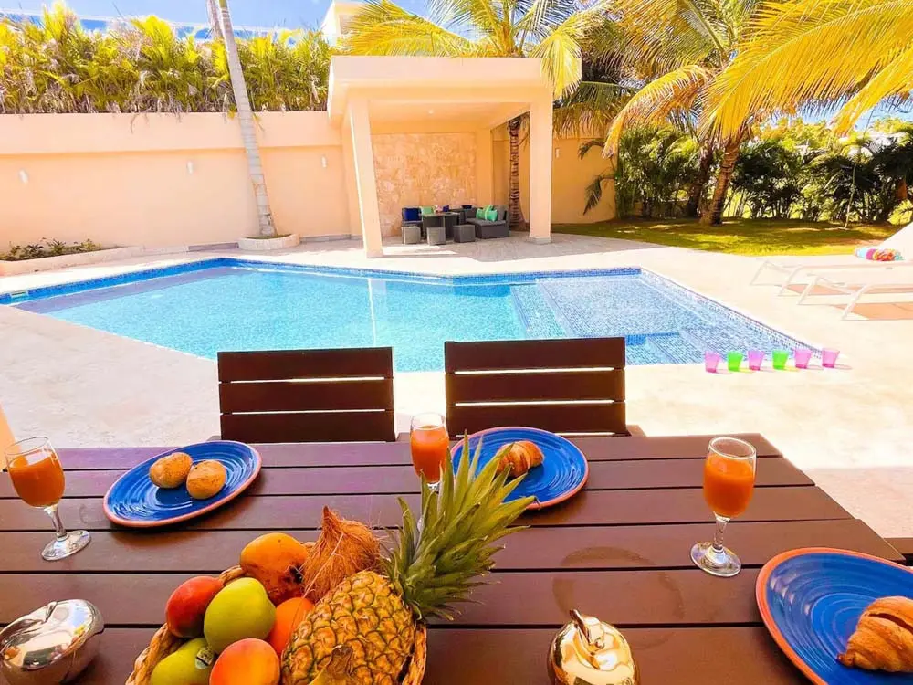 A table by the pool in a villa at Playa Palmera Beach Resort