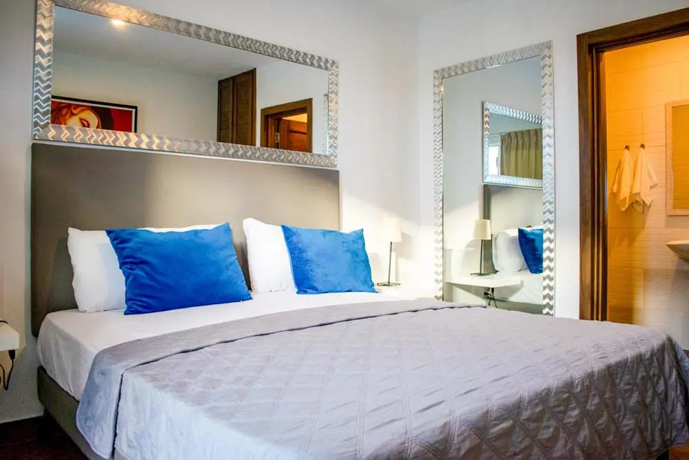 Elegant bedroom with blue pillows of the villa at Playa Palmera Beach Resort