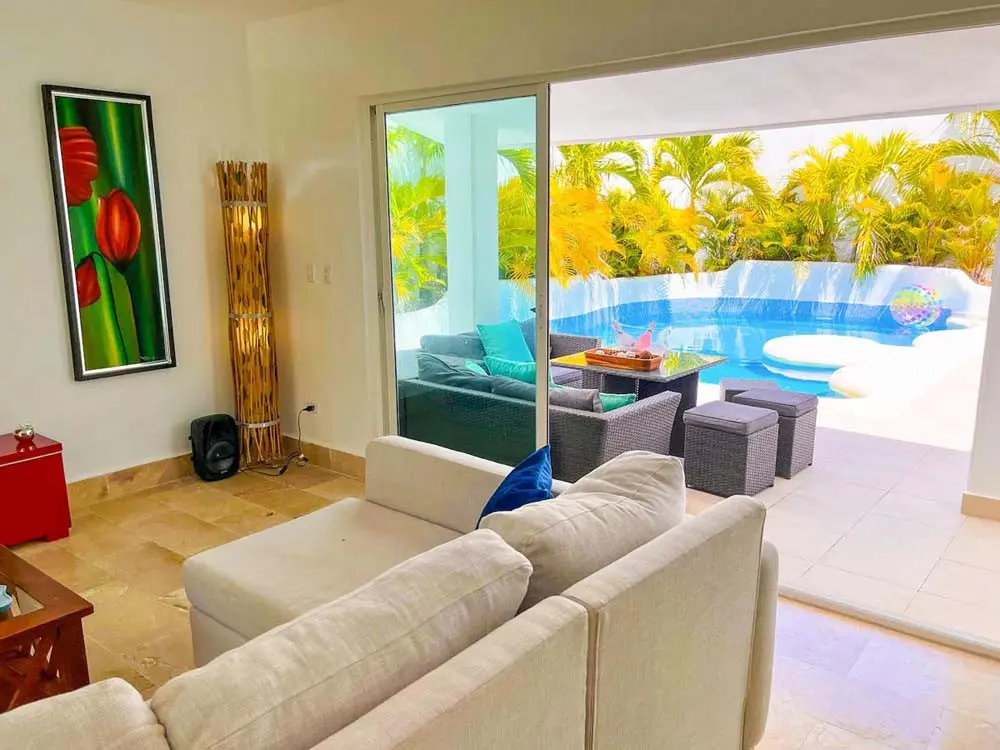 View of the living room and exit to the private pool in the villa at Playa Palmera Beach Resort
